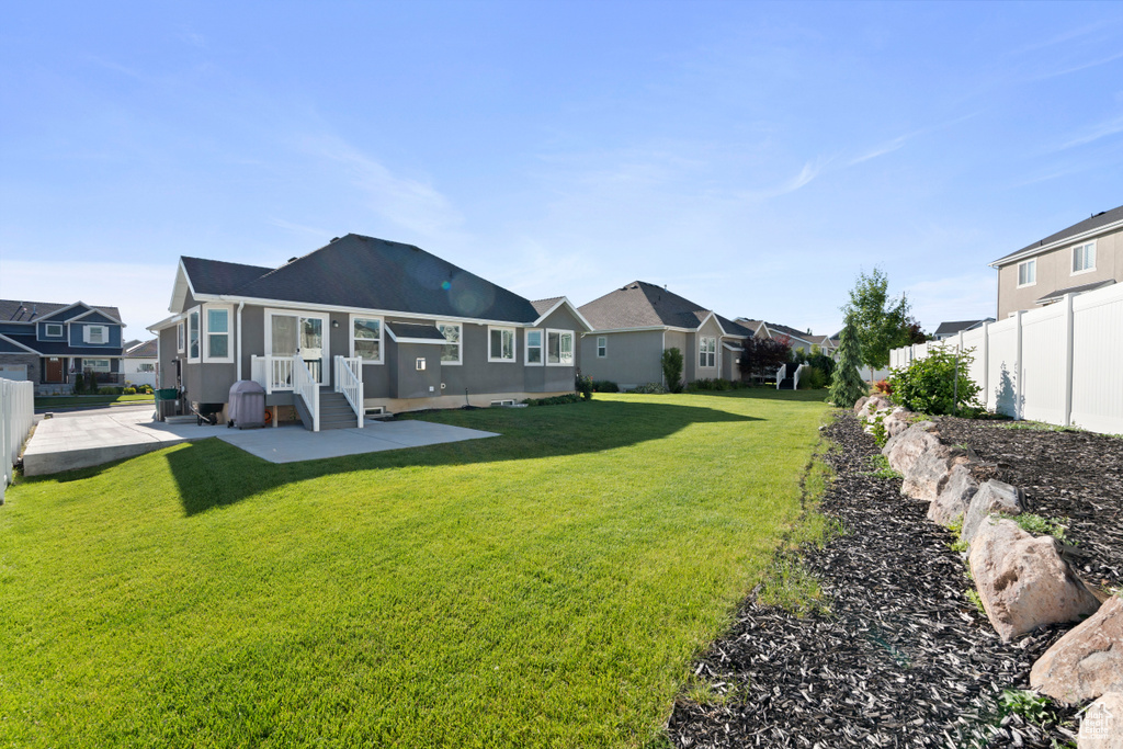 Rear view of property featuring a residential view and a patio