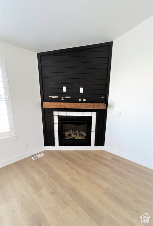 Detailed view of a fireplace and wood finished floors