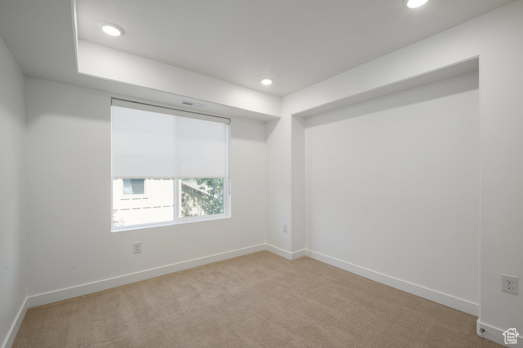 Unfurnished room with recessed lighting and carpet