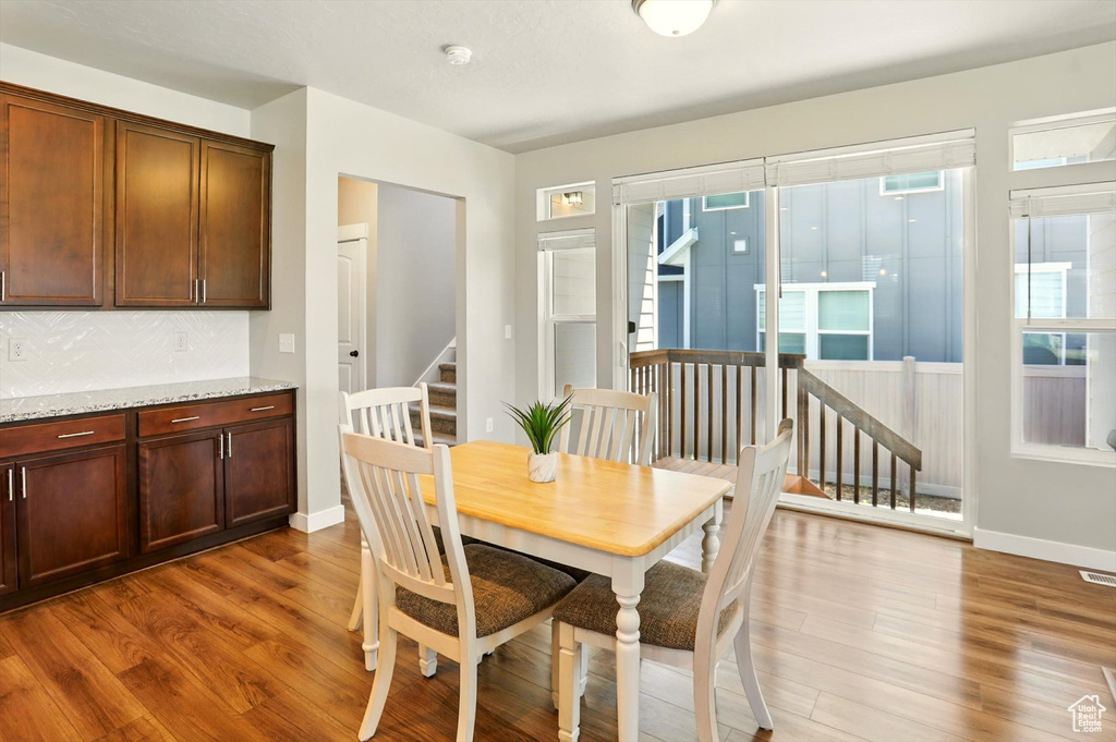 Dining area featuring wood finished floors and stairway