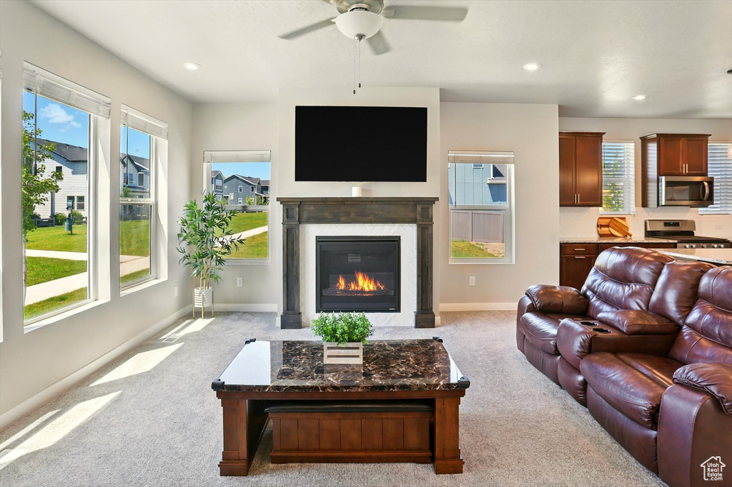 Living area featuring carpet floors, a ceiling fan, plenty of natural light, and recessed lighting