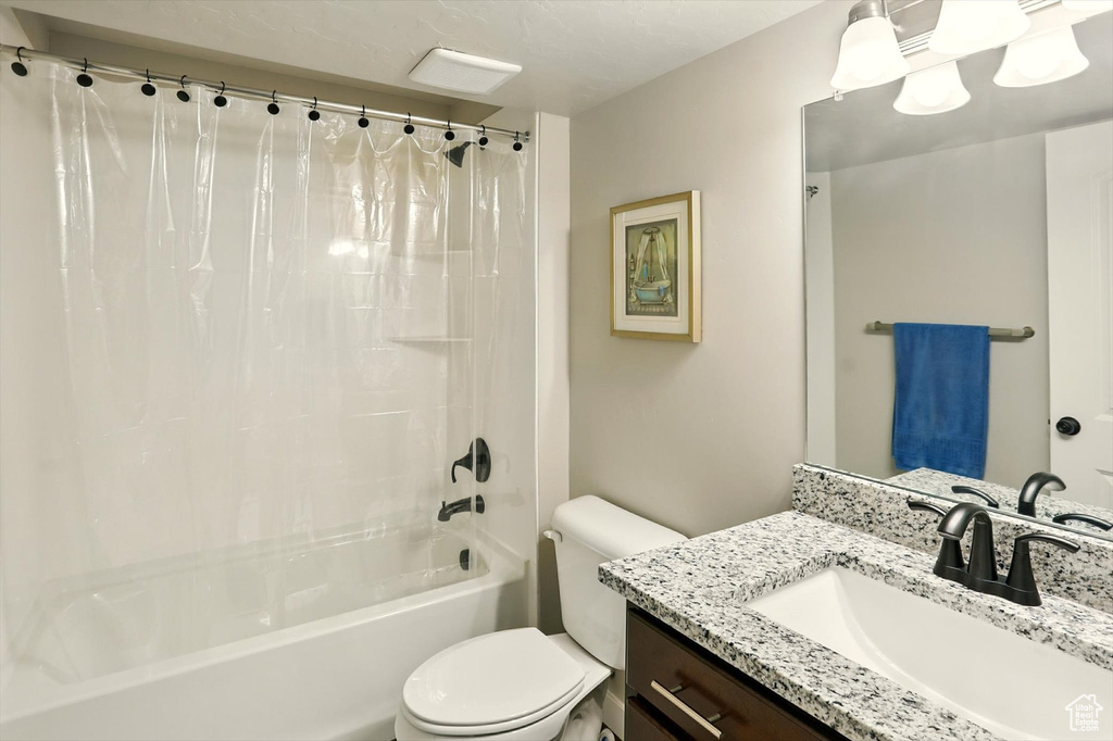 Full bath featuring shower / bath combo with shower curtain and vanity