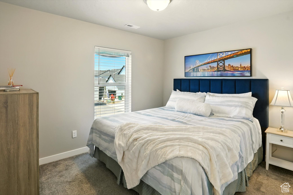 Carpeted bedroom with baseboards