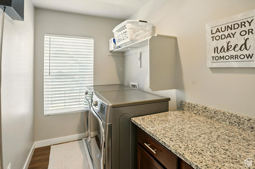 Laundry room featuring separate washer and dryer and dark wood finished floors