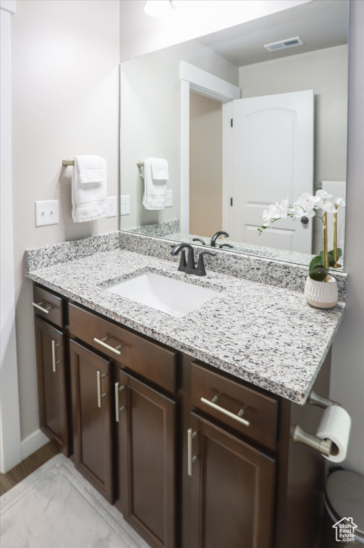Bathroom featuring vanity and wood finished floors
