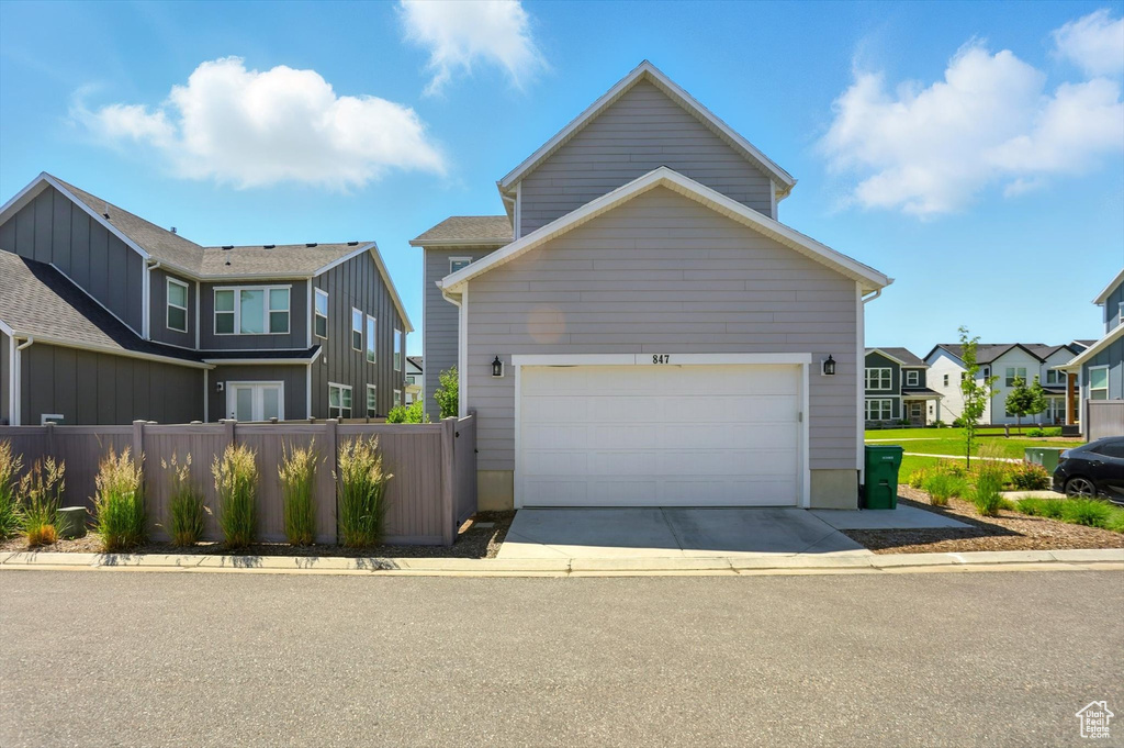 View of front of property featuring driveway and a residential view