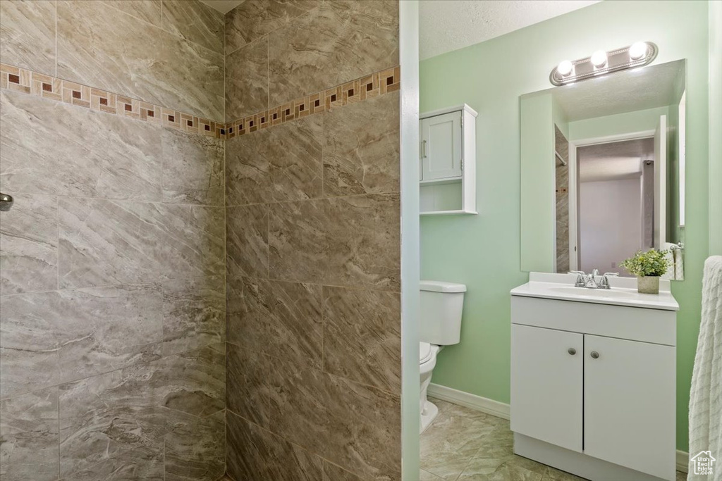 Bathroom featuring vanity and a tile shower
