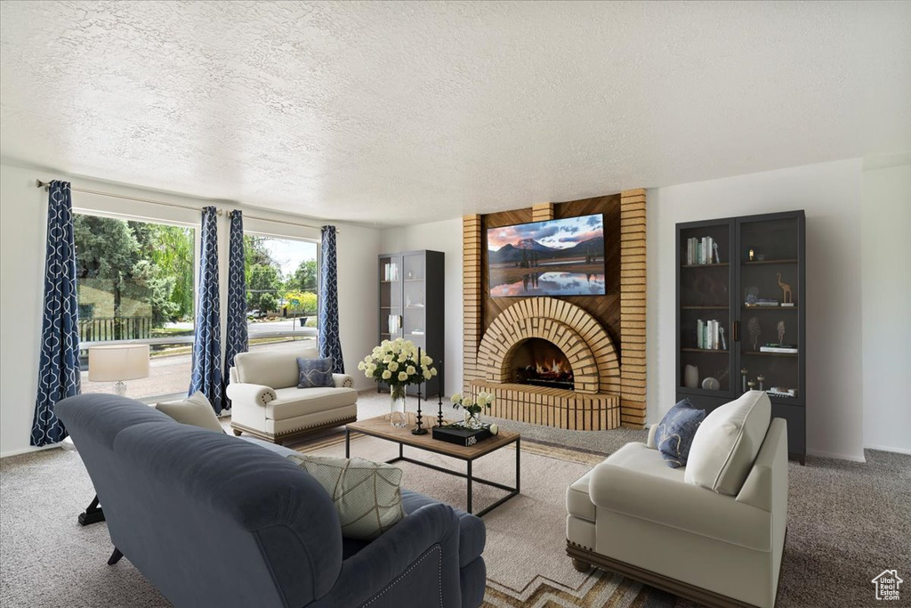 Carpeted living area featuring a textured ceiling and a brick fireplace