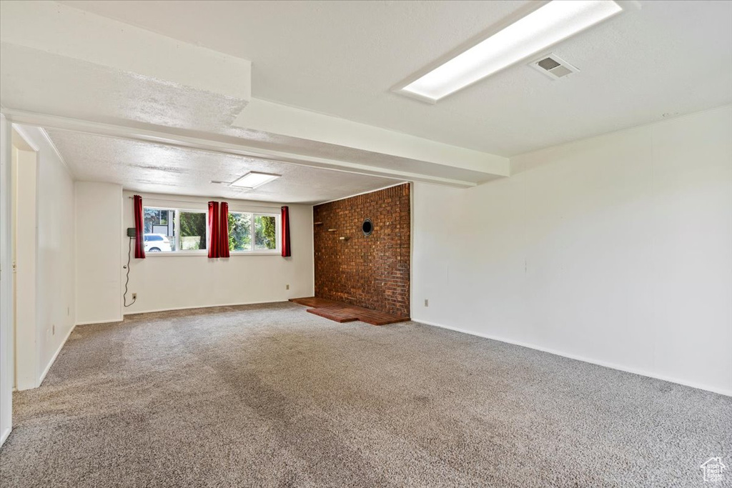 Carpeted spare room with baseboards