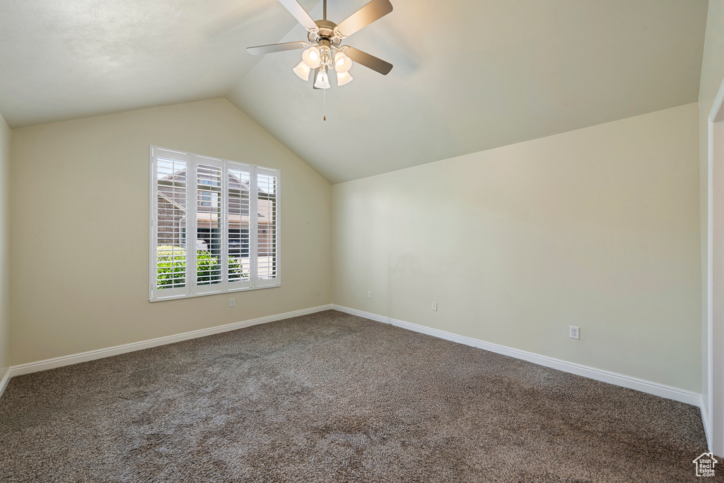 Bonus room featuring carpet floors, ceiling fan, and lofted ceiling