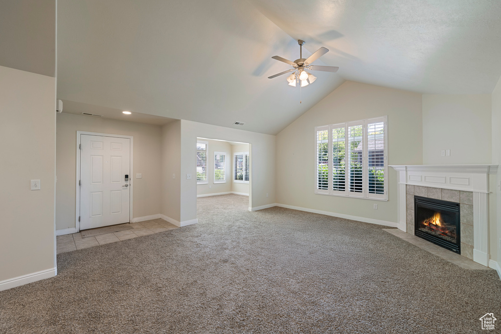Unfurnished living room with light carpet, ceiling fan, a fireplace, lofted ceiling, and recessed lighting
