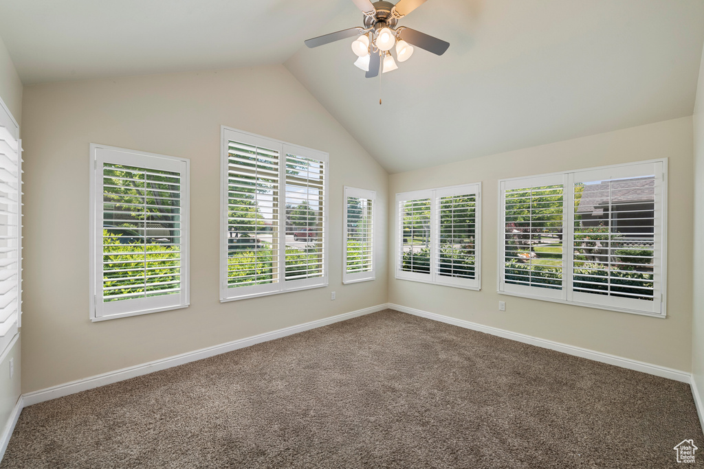 Unfurnished room with carpet floors, vaulted ceiling, and ceiling fan