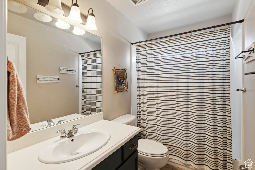 Full bath featuring vanity and a shower with curtain