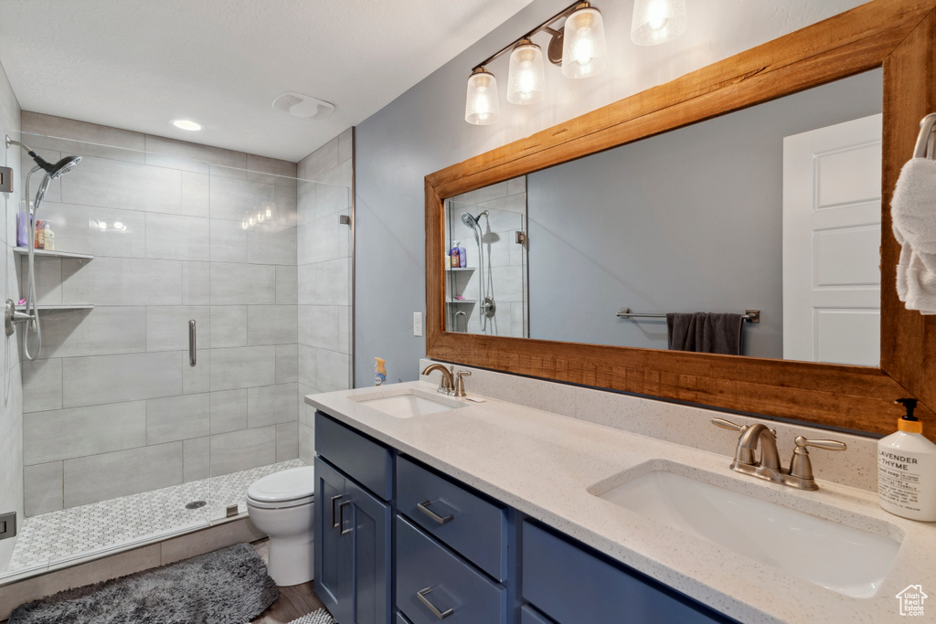 Bathroom with a shower stall and double vanity