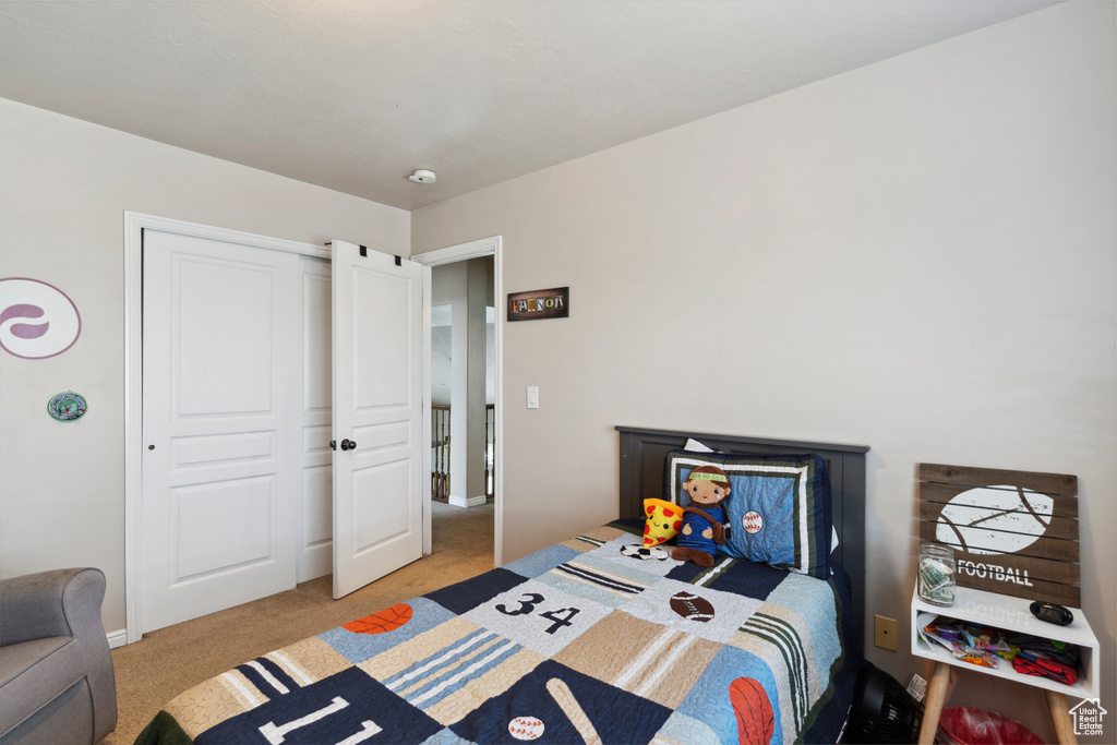 Bedroom with light colored carpet