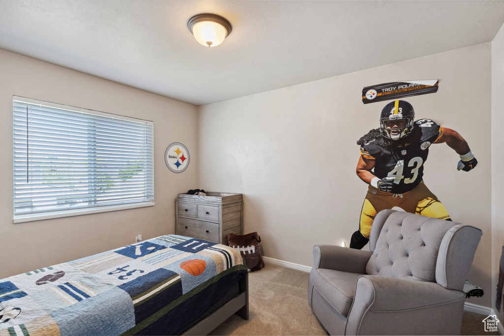 Bedroom featuring carpet floors and baseboards