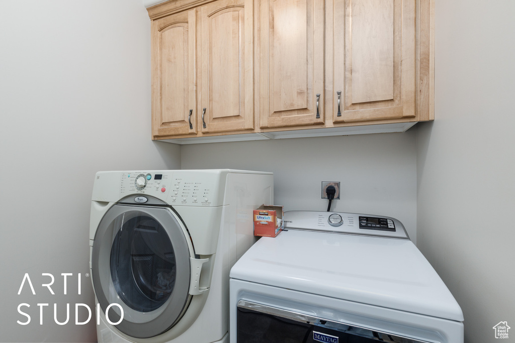 Washroom with cabinet space and separate washer and dryer