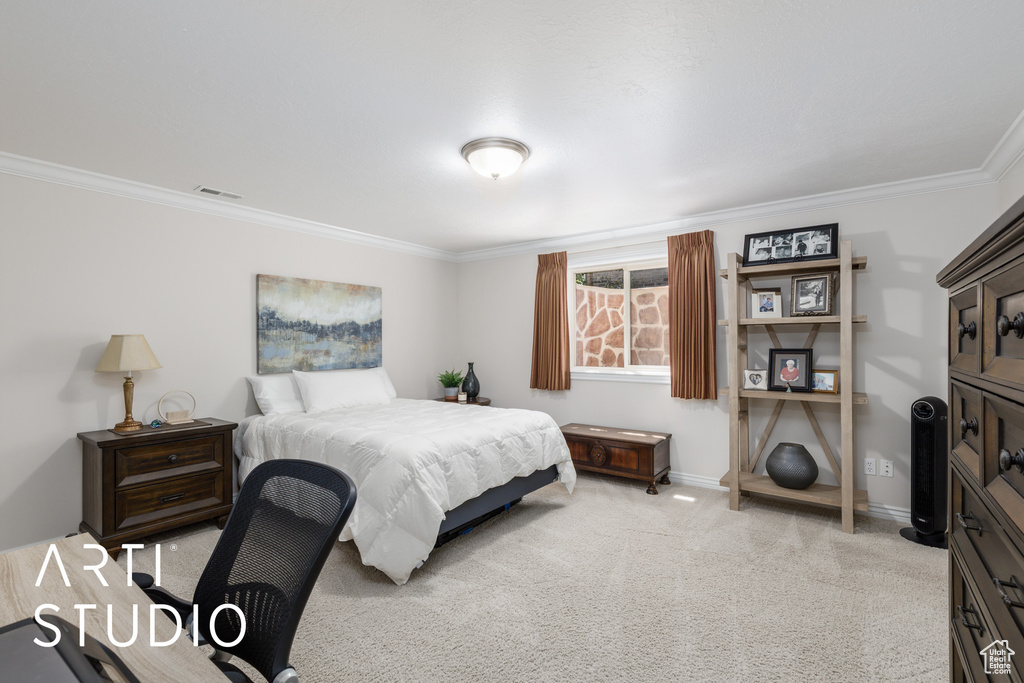 Bedroom with crown molding and light carpet