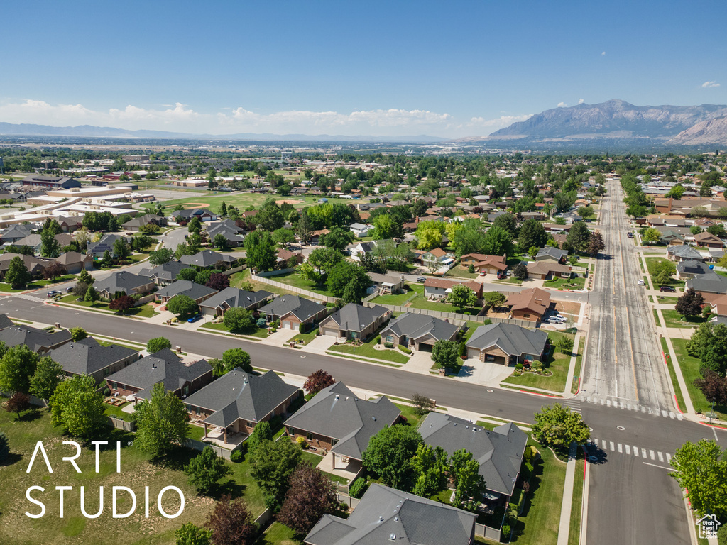 Aerial perspective of suburban area featuring a mountainous background