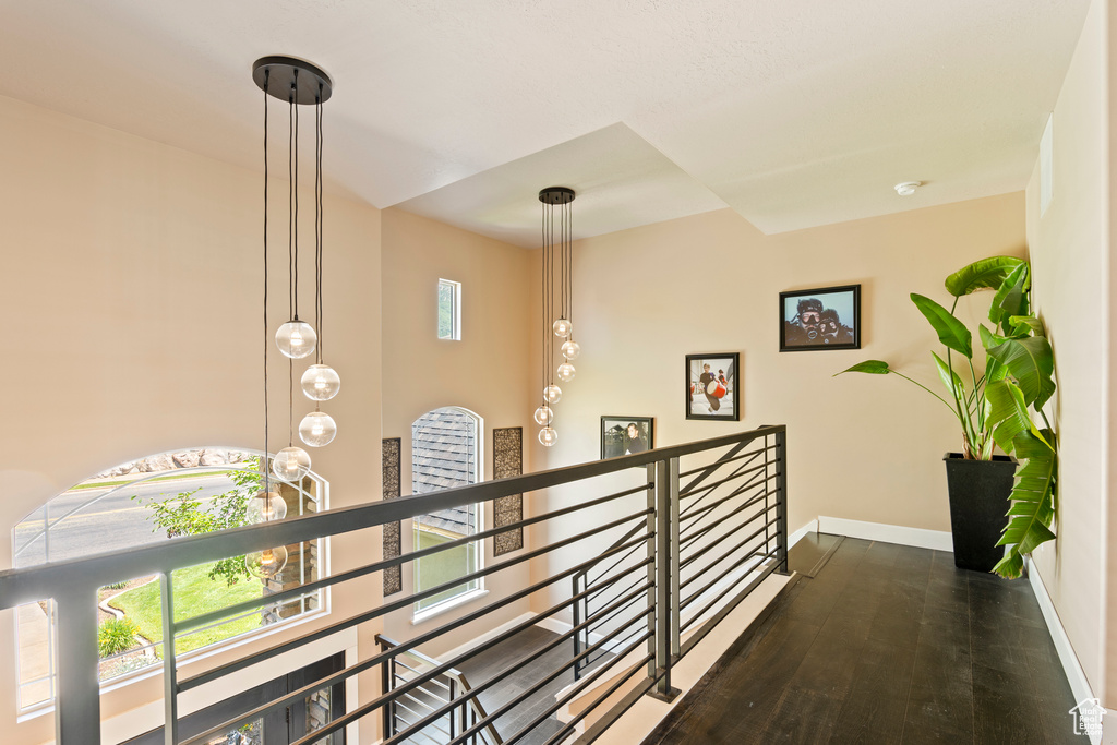Hallway with an upstairs landing and wood finished floors