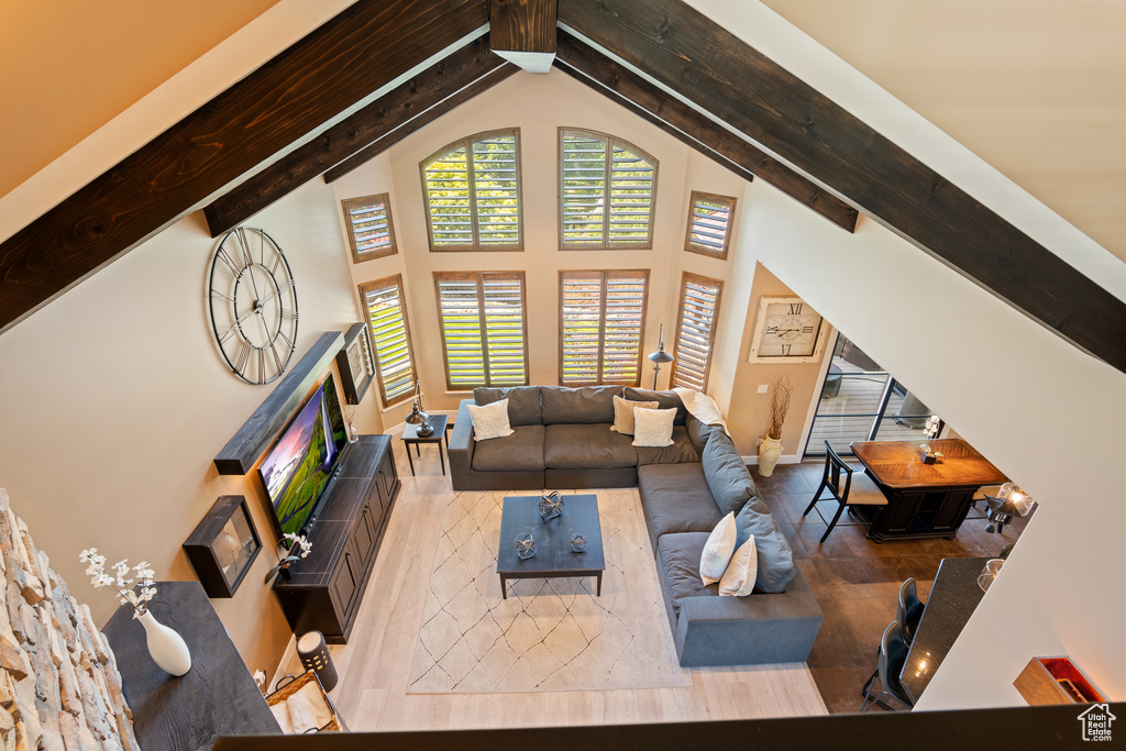 Living room with high vaulted ceiling and beamed ceiling