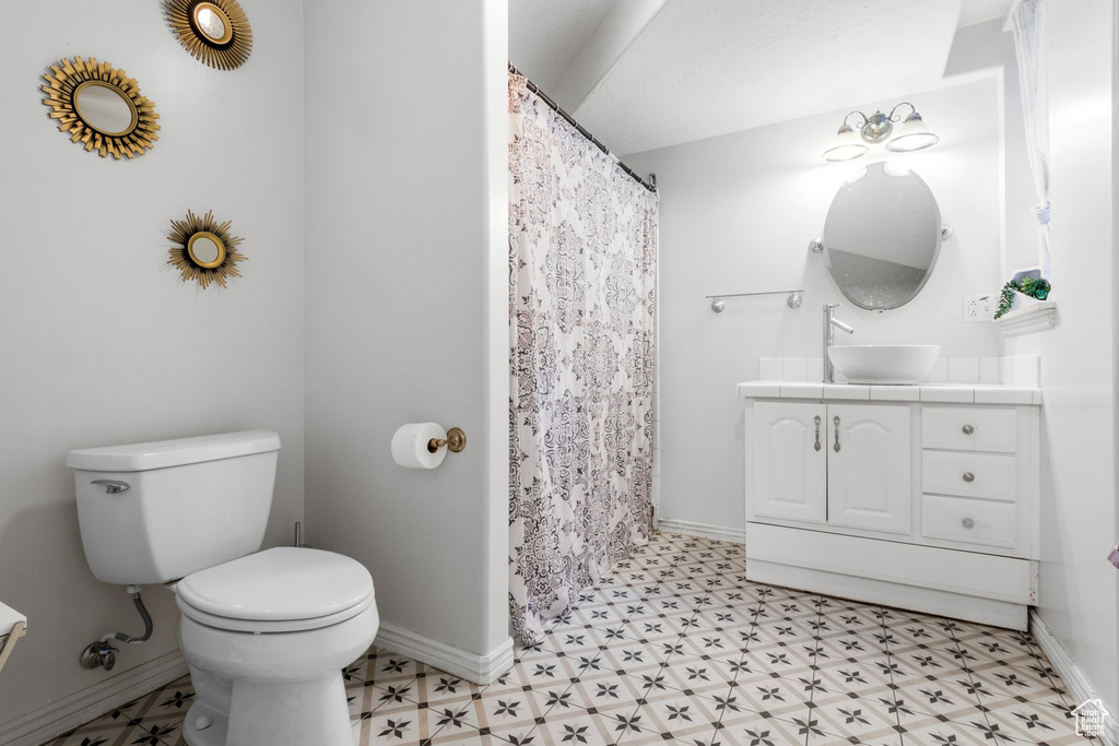 Full bath featuring tile patterned floors, vanity, and a shower with curtain