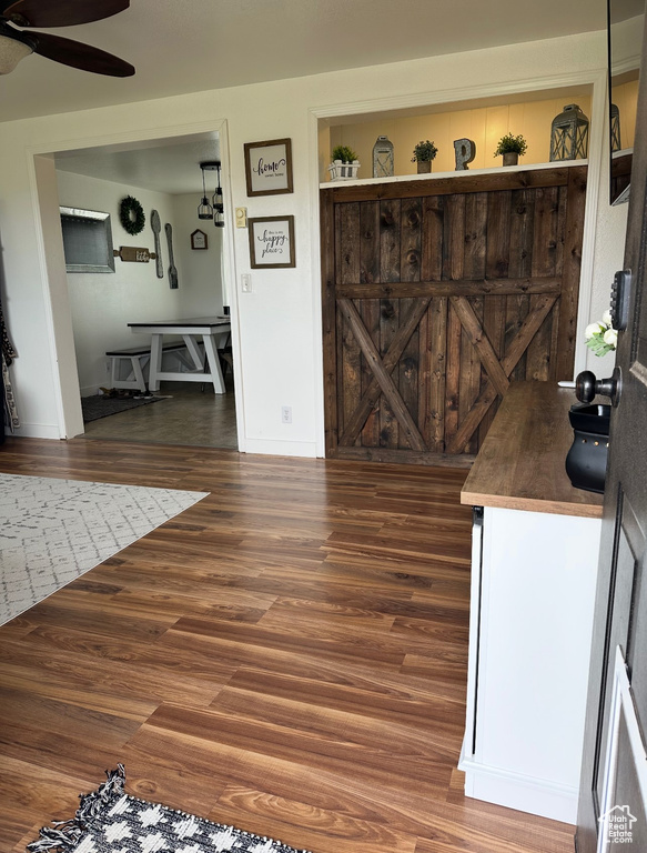 Dining space with ceiling fan and wood finished floors