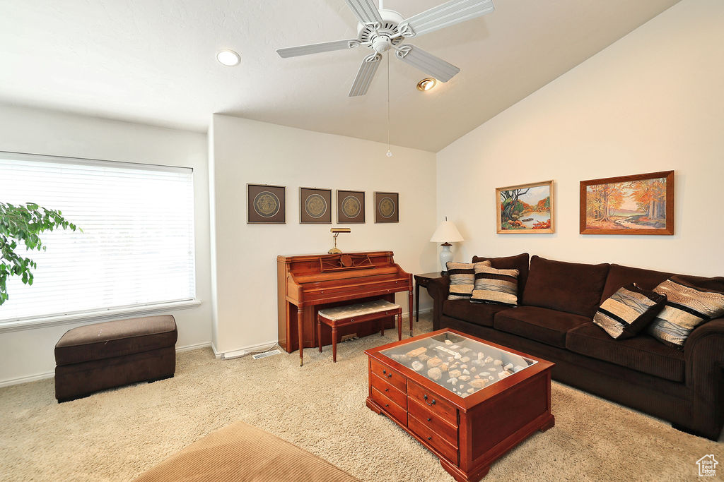 Living area with a ceiling fan, light carpet, recessed lighting, and vaulted ceiling