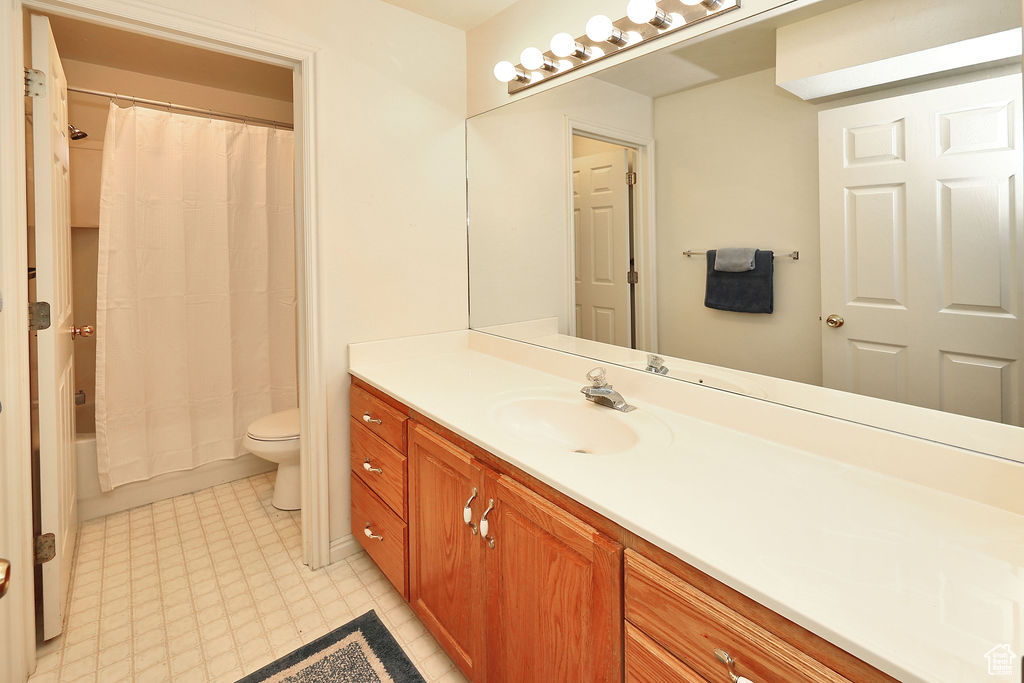 Full bathroom with vanity and shower / bathtub combination with curtain