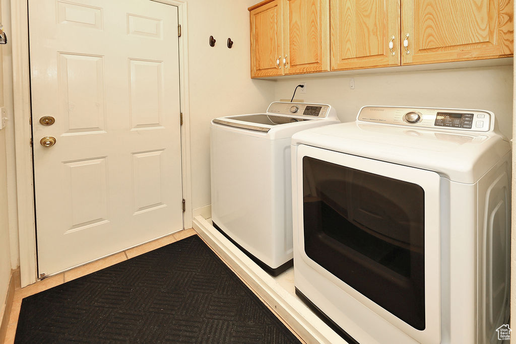 Laundry room with washing machine and clothes dryer and cabinet space