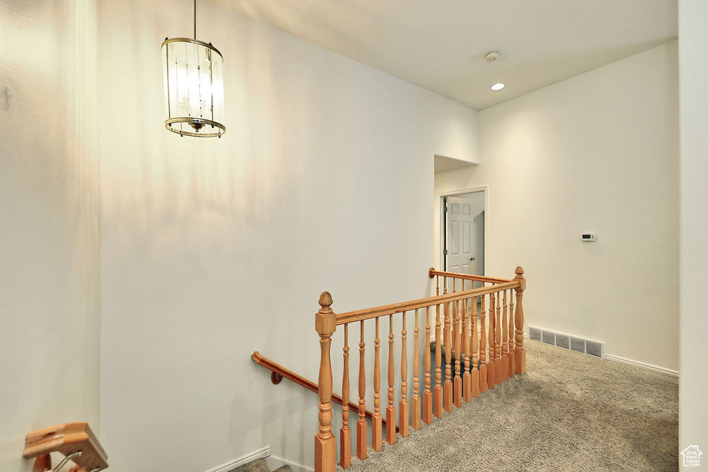 Stairs featuring carpet floors, a chandelier, and recessed lighting