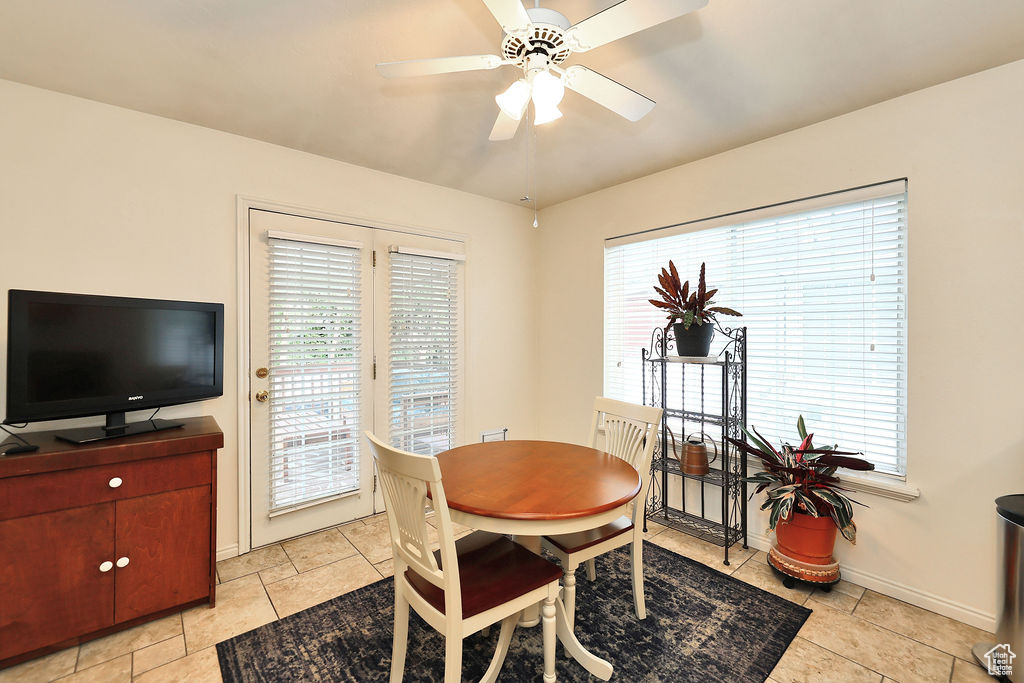 Dining room featuring healthy amount of natural light, a ceiling fan, and light tile patterned floors