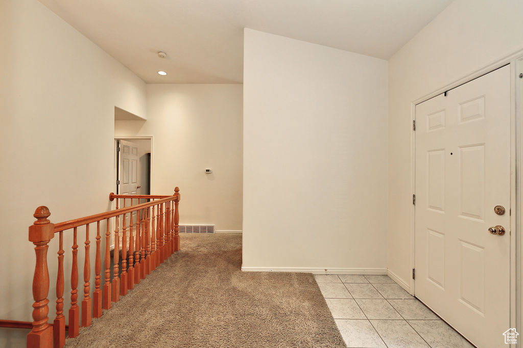 Foyer featuring light colored carpet, recessed lighting, and light tile patterned floors
