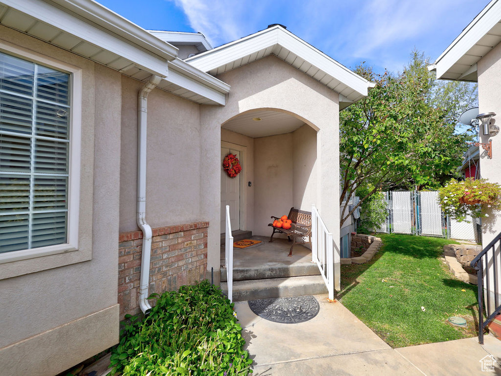 Property entrance with stucco siding and a gate