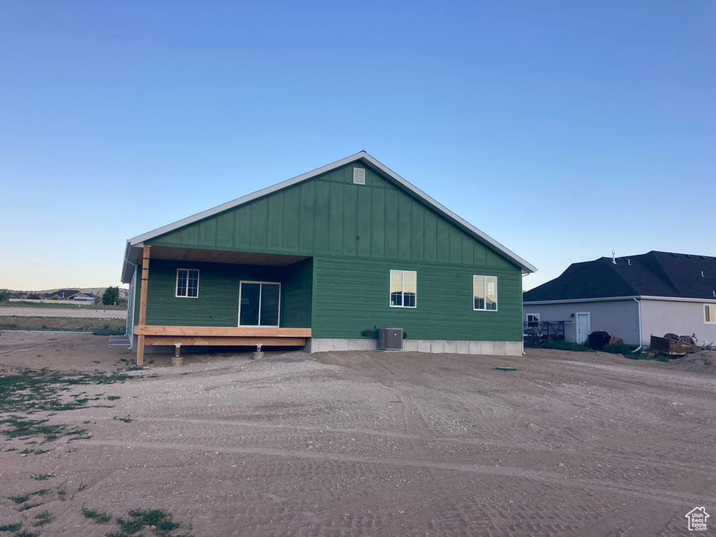 View of property exterior featuring a cooling unit and board and batten siding