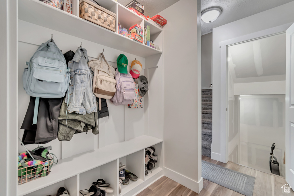 Mudroom with wood finished floors and baseboards