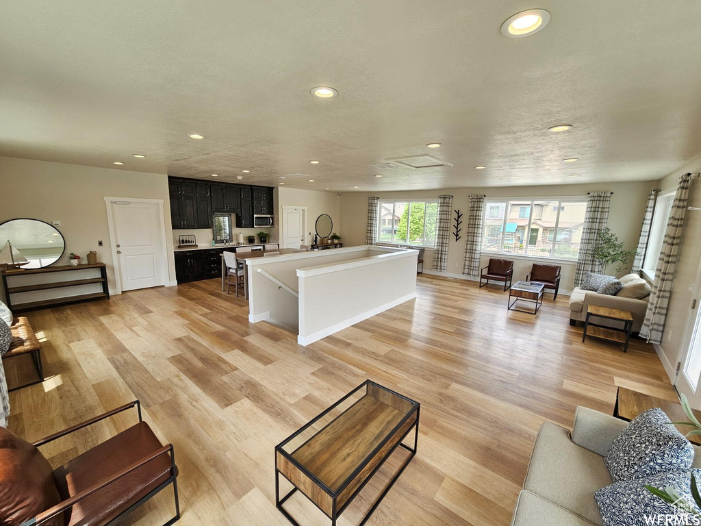 Living room with recessed lighting and light wood finished floors