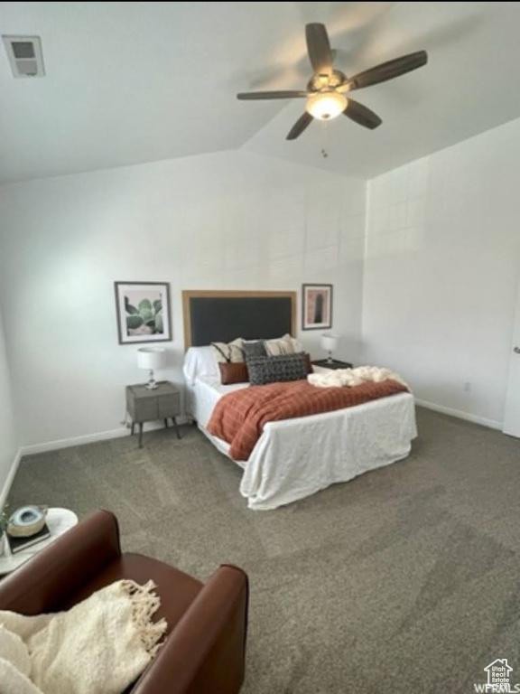 Carpeted bedroom featuring lofted ceiling and ceiling fan