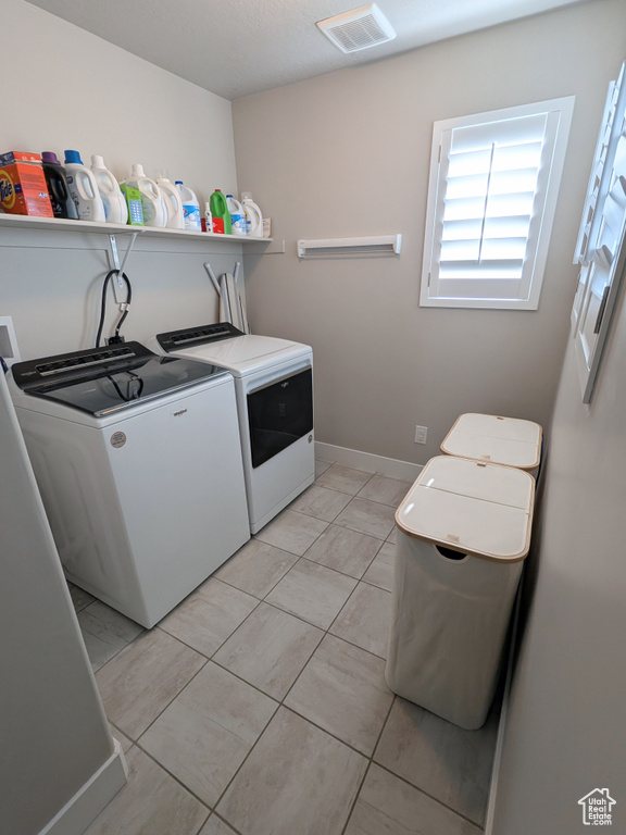 Laundry area with washer and clothes dryer and baseboards