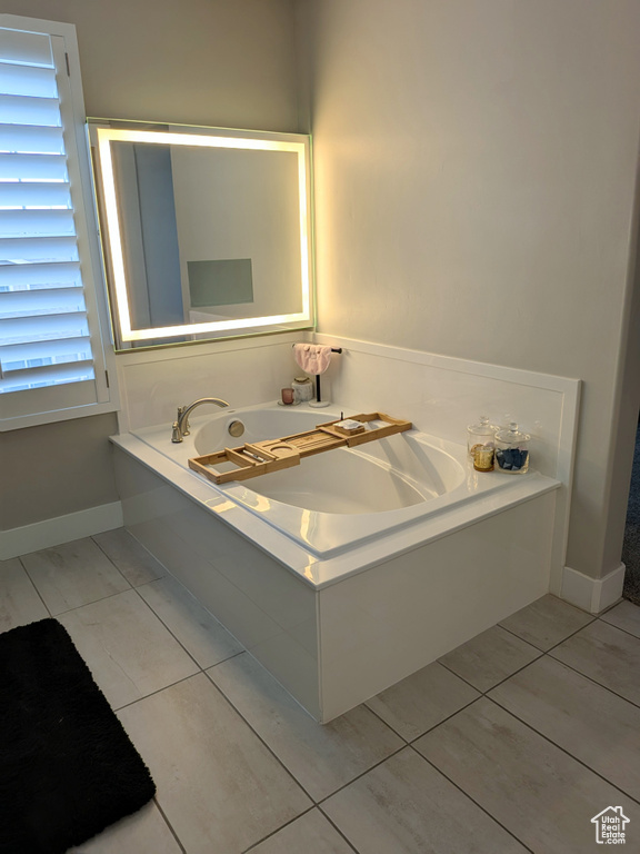 Full bathroom featuring a bath and tile patterned floors