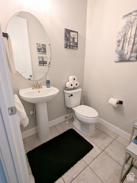 Bathroom with toilet and baseboards