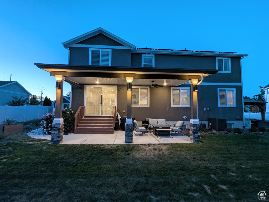 Back of house featuring ceiling fan, stucco siding, outdoor lounge area, and a patio
