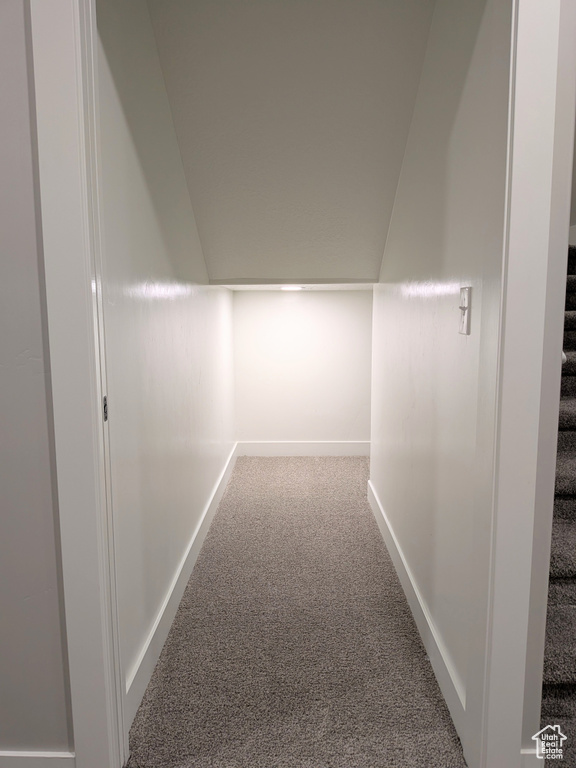 Hallway with carpet flooring and stairs