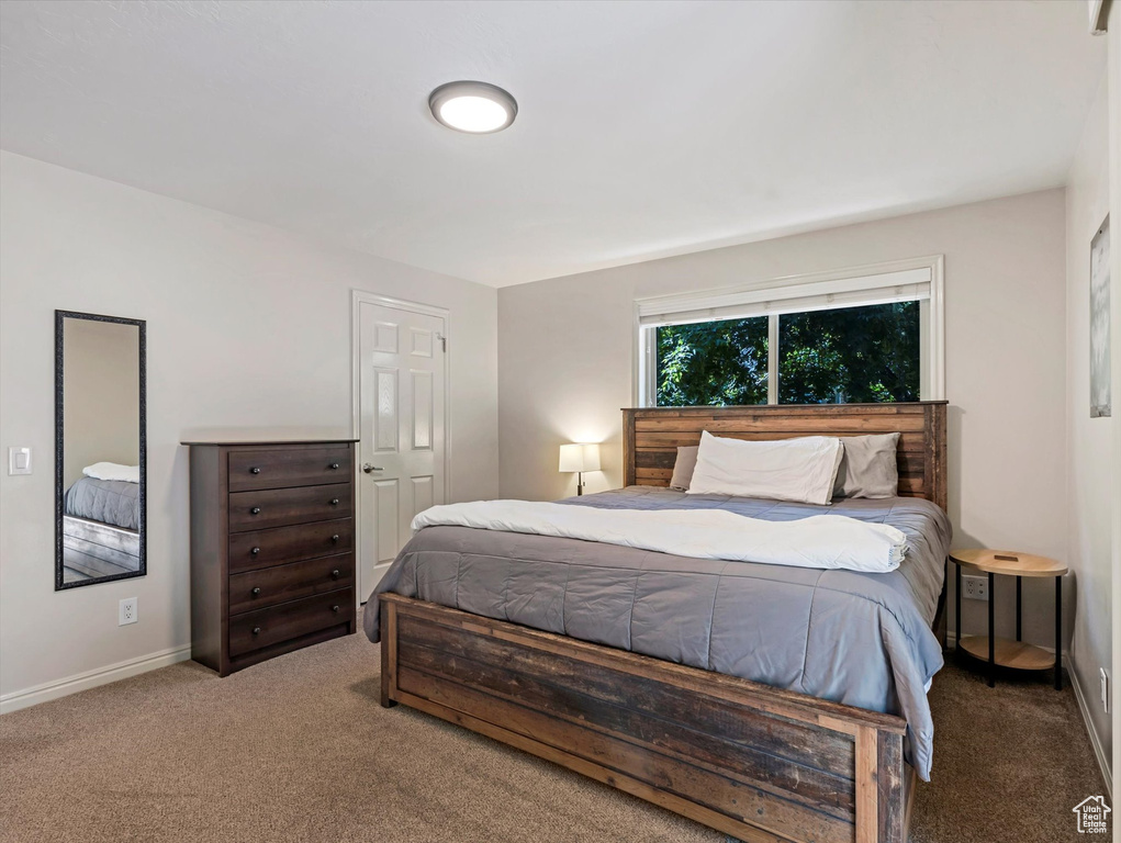 Carpeted bedroom with baseboards