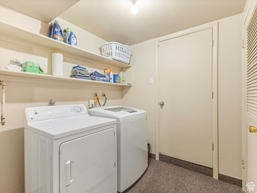 Laundry room featuring separate washer and dryer and baseboards