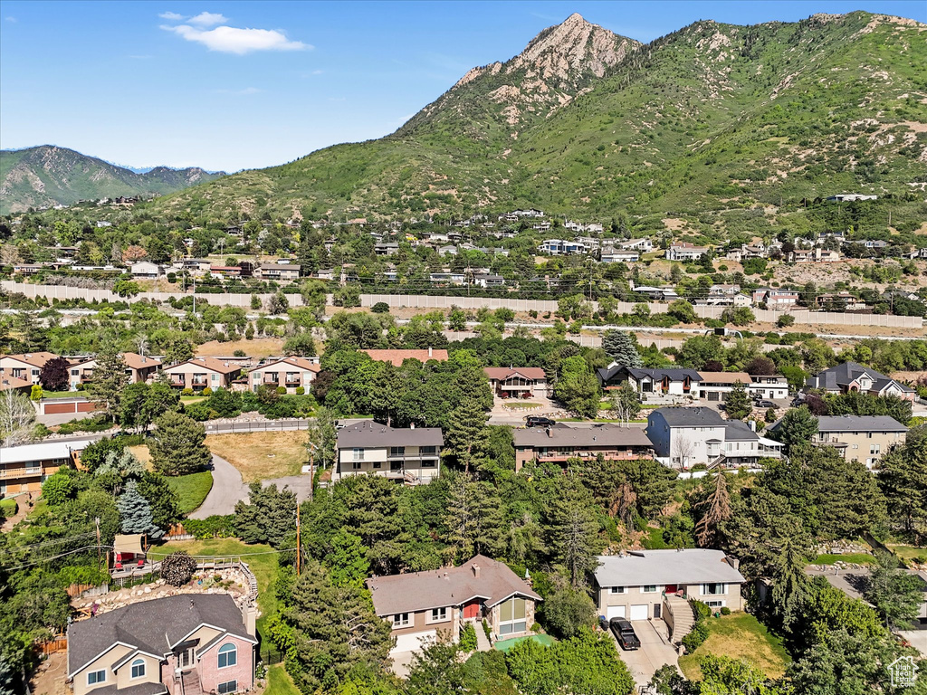 Aerial view of property and surrounding area with a mountainous background