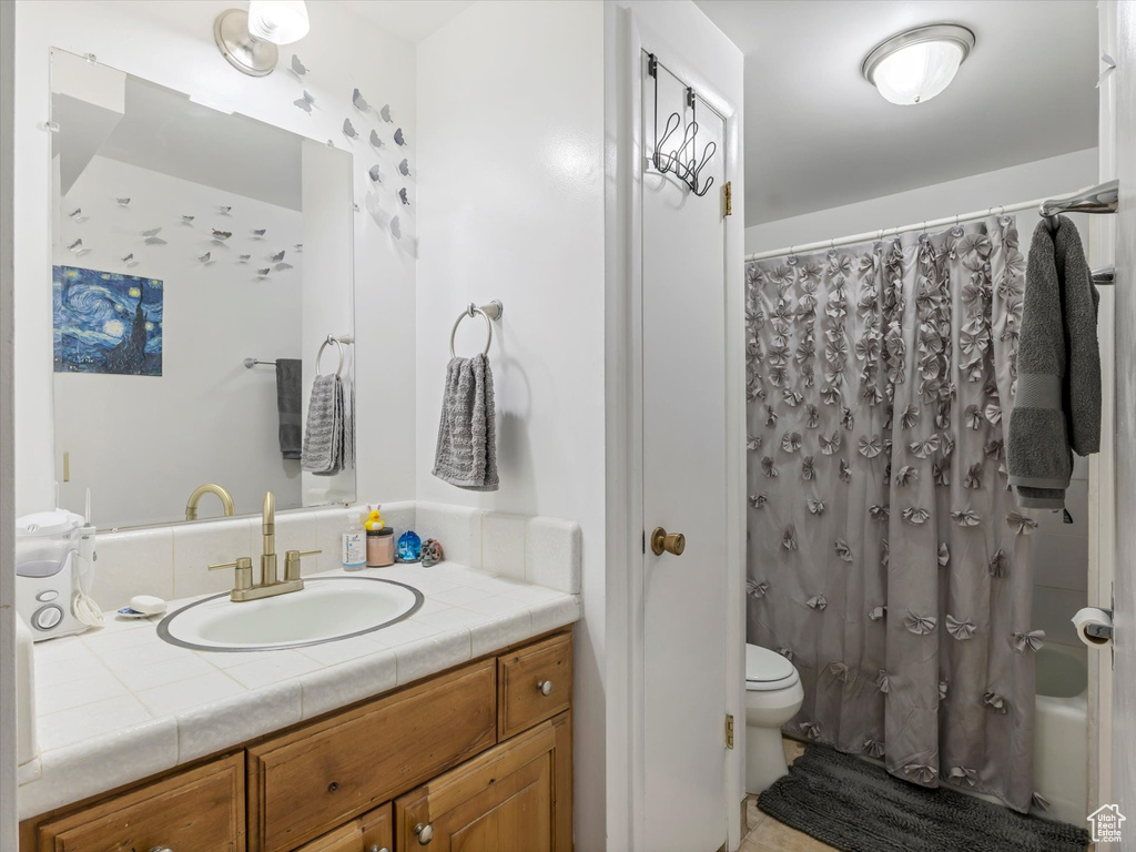Bathroom featuring vanity and shower / tub combo with curtain