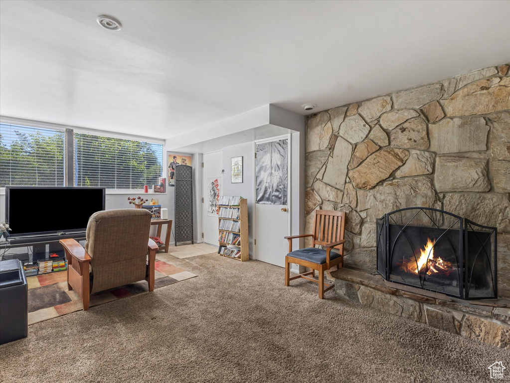 Living area with carpet and a fireplace