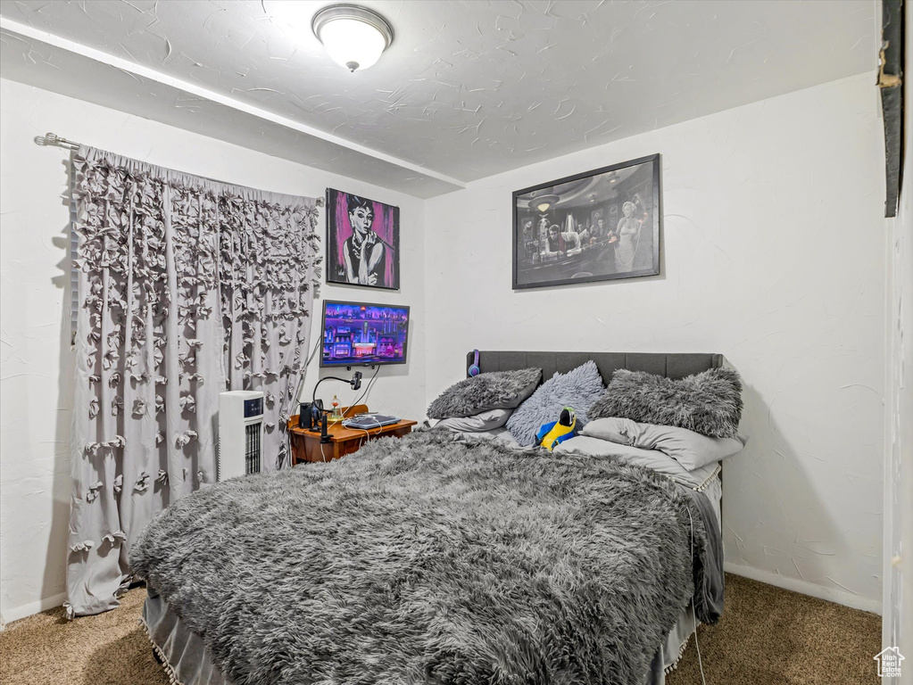 Carpeted bedroom with baseboards