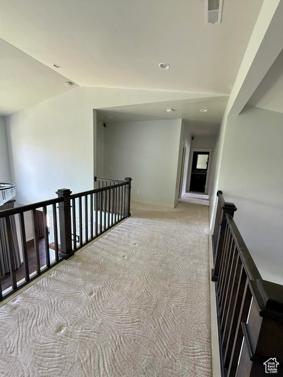 Corridor featuring an upstairs landing, carpet flooring, lofted ceiling, recessed lighting, and plenty of natural light